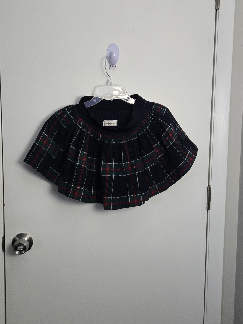 Classic plaid circle skirt in navy with red and green accents.